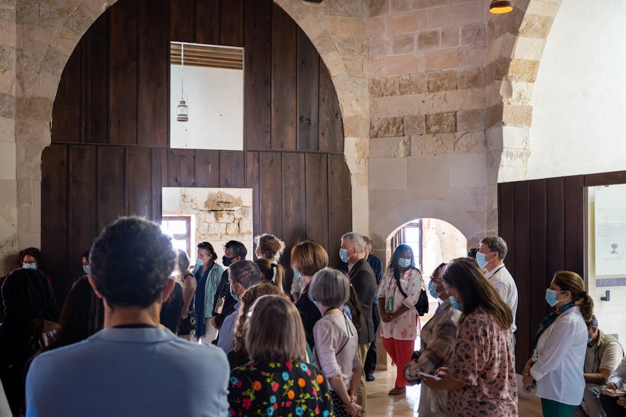 Delegates standing outside the Prison Cell of Bahá’u’llah.