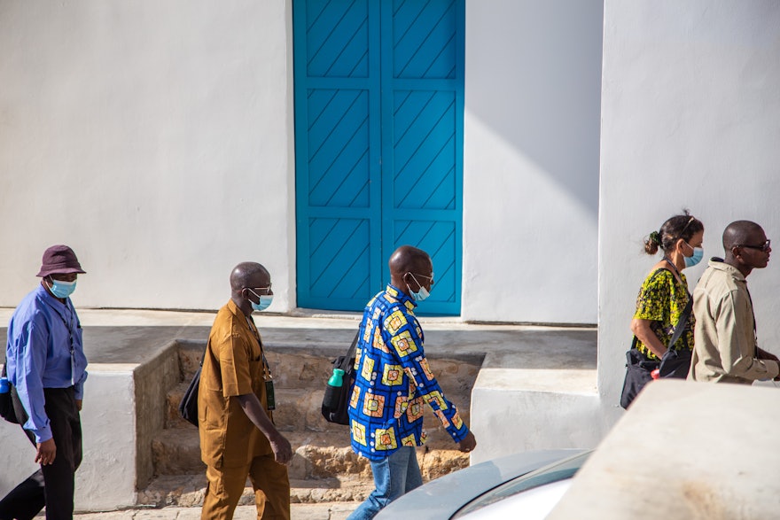 A group of delegates pass by the doors of the House of ‘Abbúd.