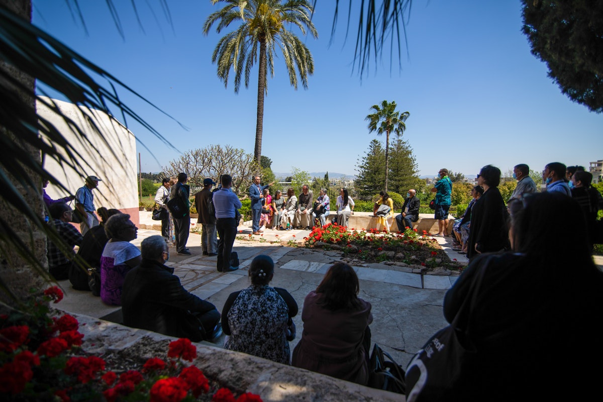 Delegates listen to a guide speak during their visit to the Mansion of Mazra‘ih.