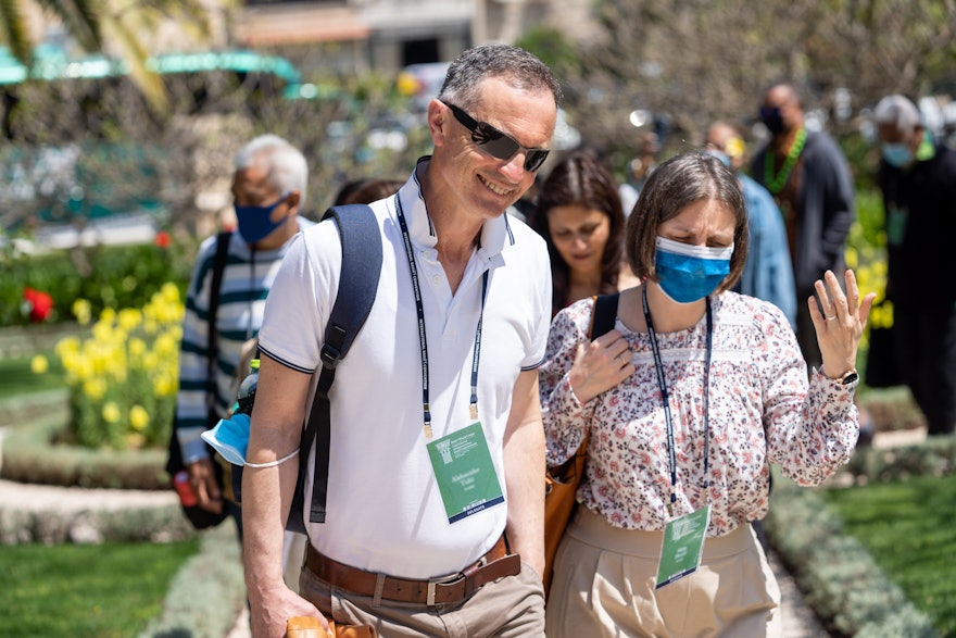 Delegates from Croatia approach     the former Pilgrim House near the House of ‘Abdu’l-Bahá.