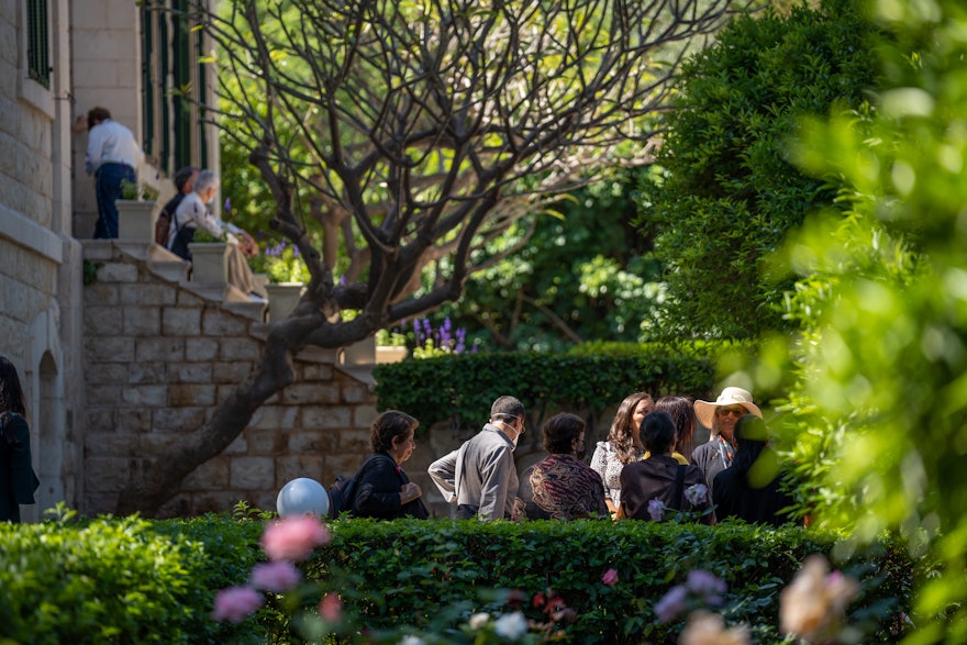 Delegates gather in the gardens of the House of ‘Abdu’l-Bahá.