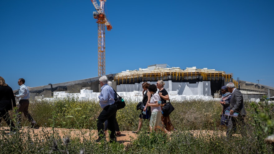 A group of delegates at the construction site for the Shrine of ʻAbdu'l-Bahá.