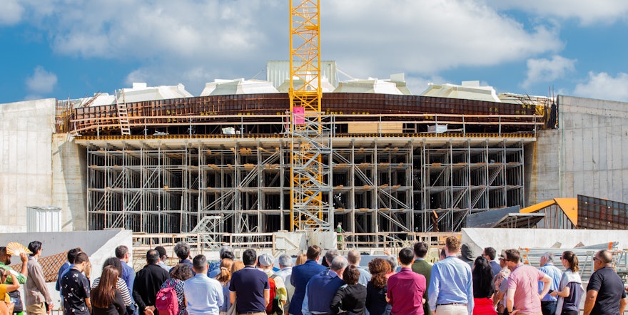 Representatives and other convention participants gather in front of the south plaza of the future Shrine of ʻAbdu'l-Bahá.