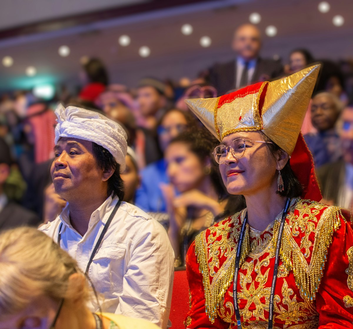 A delegate from Indonesia listens to opening remarks of the 13th International Bahá’í Convention.