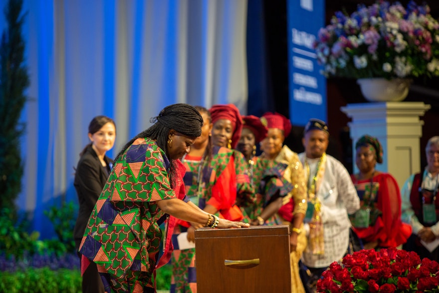 A delegate from Nigeria casts her ballot for the election of the Universal House of Justice.