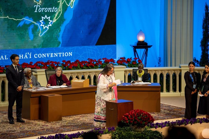 A delegate from Canada casts her ballot for the election of the Universal House of Justice