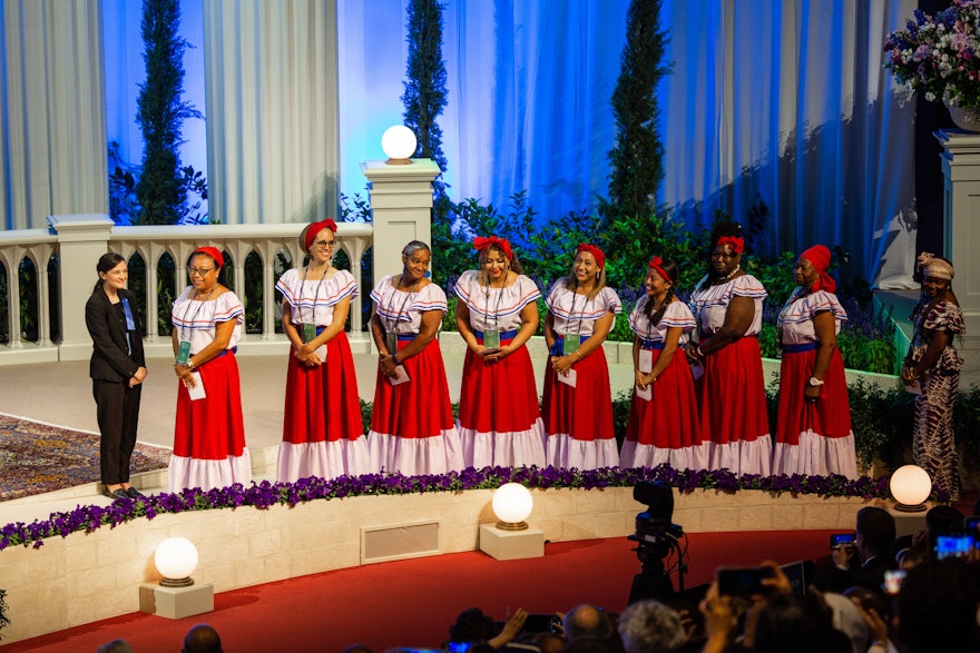 Delegates from Belize line up on stage to cast their ballots for the election of the Universal House of Justice.