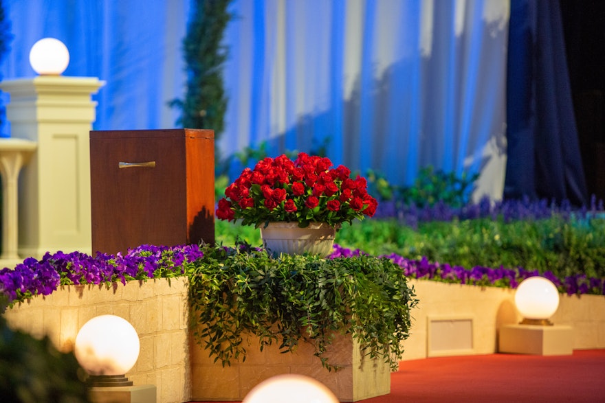 A bouquet of red roses was presented to the convention on behalf the Bahá’ís in Iran, who because of continuing persecution in their homeland could not attend the gathering or participate in the election. The flowers sit onstage, front and center, during convention sessions in Haifa.