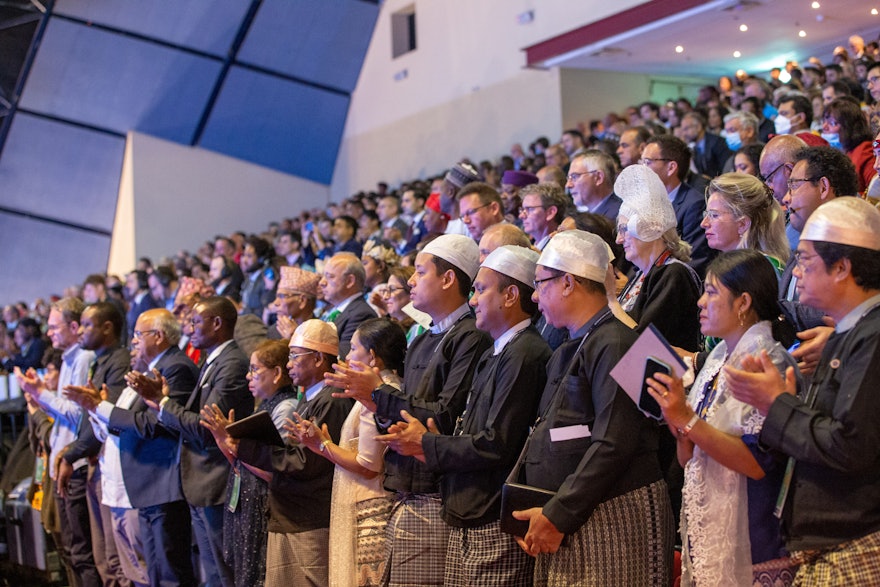 Delegates applaud during the opening session of the 13th International Baha’i Convention.