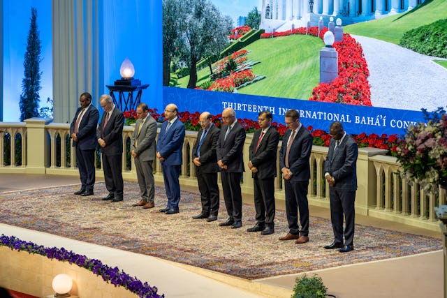 The members of the Universal House of Justice are, from left to right, Chuungu Malitonga, Paul Lample, Juan Francisco Mora, Ayman Rouhani, Payman Mohajer, Shahriar Razavi, Praveen Mallik, Andrej Donoval, and Albert Nshisu Nsunga. The House of Justice was elected by delegates to the 13th International Bahá’í Convention in Haifa.