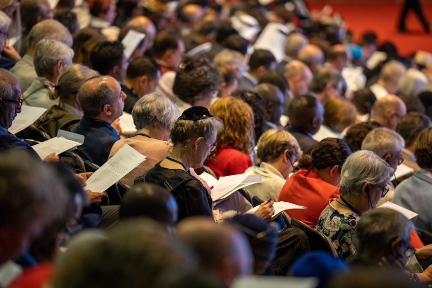 Delegates to the 13th International Bahá’í Convention read Riḍván message of the Universal House of Justice.