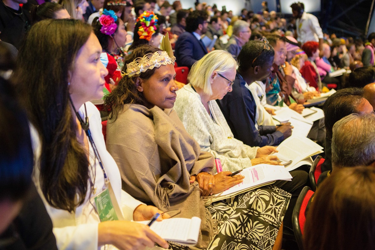 A delegate from New Caledonia (middle) during a consultative session at the 13th International Bahá’í Convention.