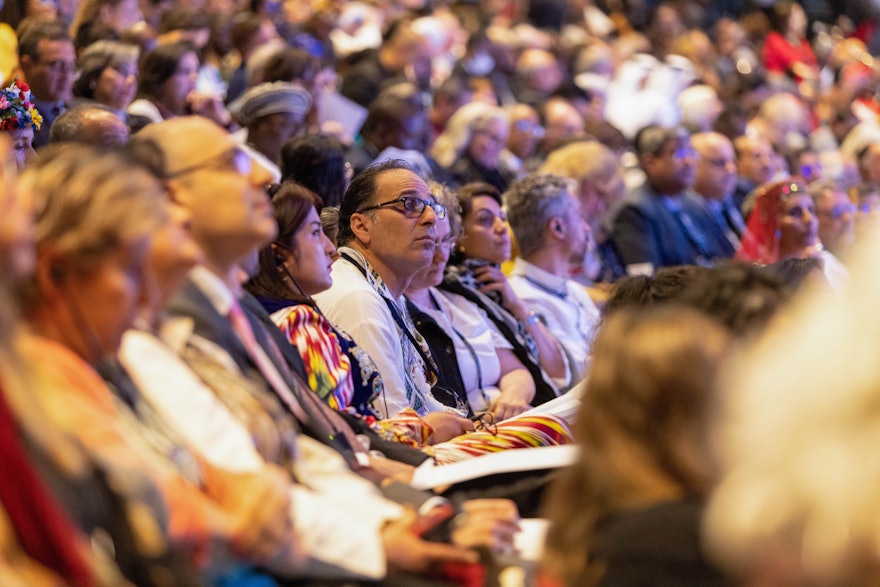 Participants listen closely to remarks by a delegate.