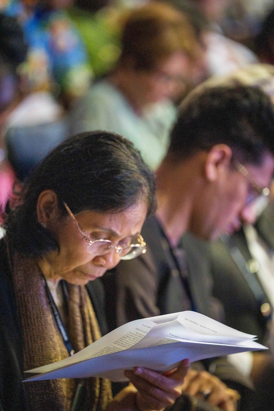 A representative from Thailand reads the Riḍván message of the Universal House of Justice.