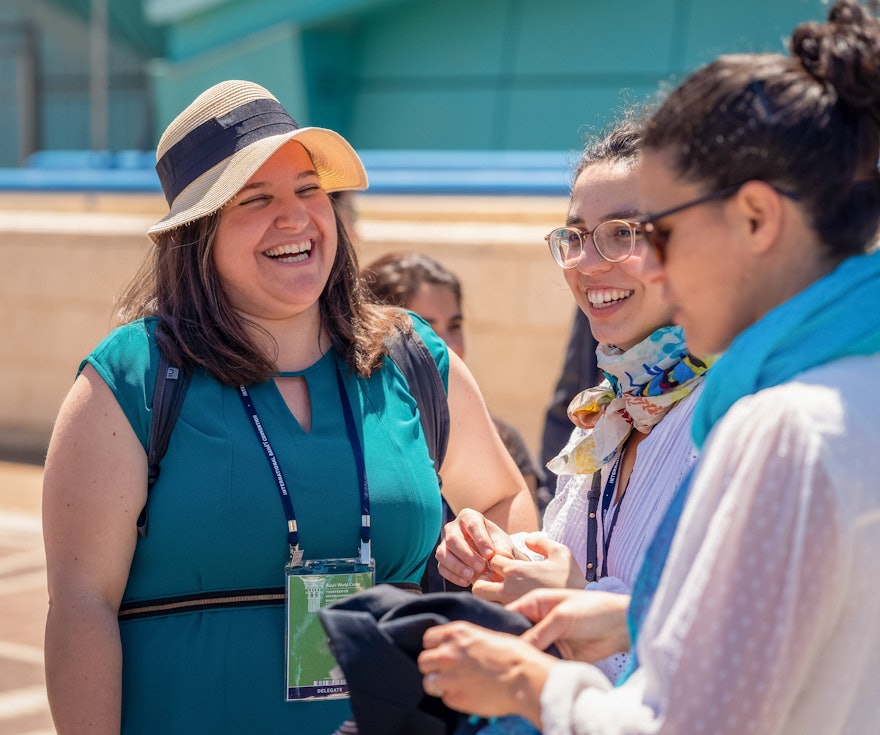 A delegate from Spain (left) with fellow Convention participants before returning to her country.