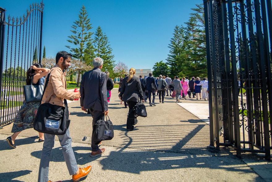 Delegates approaching the Bahjí Visitors’ Centre before the start of the 12th day of Riḍván celebrations.