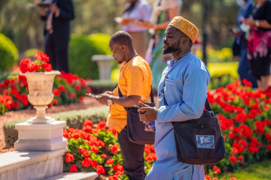 Delegates pray next to the Shrine of Baháʼu’lláh.