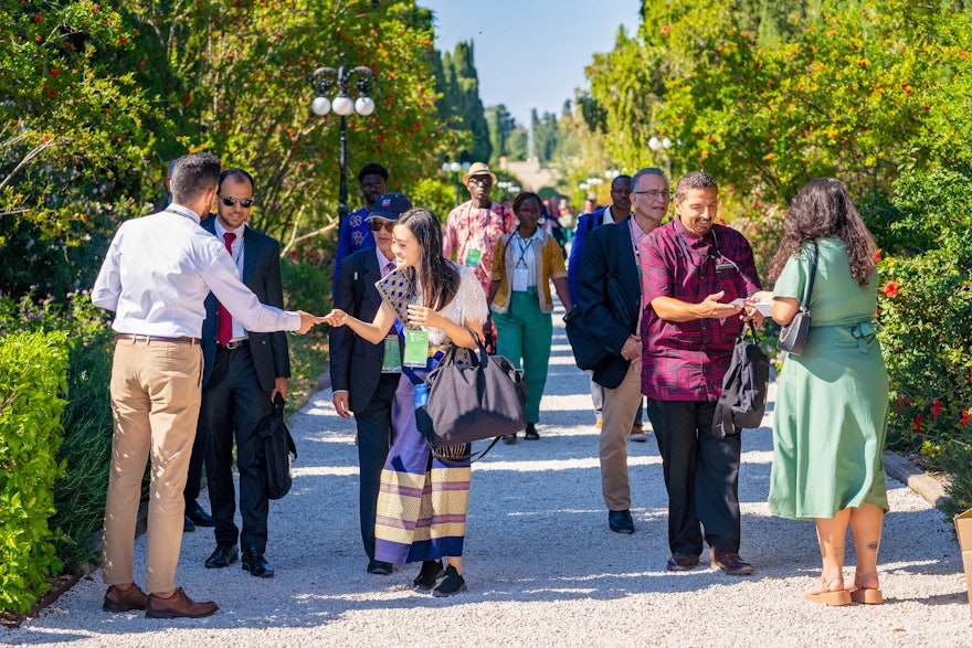 Guests are greeted and handed programs as they approach their seats for the Holy Day celebration.