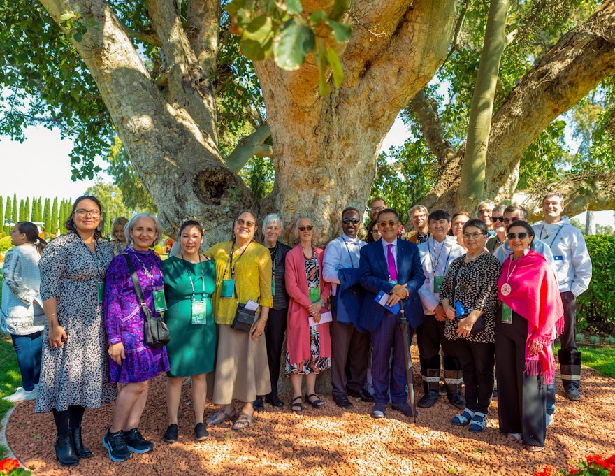 Delegates from various countries, including Canada and Greenland, at the celebration of the 12th day of Riḍván.