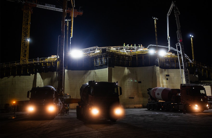 Les camions continuent de se rassembler à la base de la berme est après la tombée de la nuit.