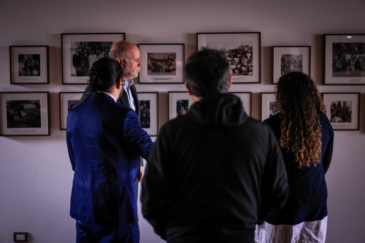 Participants viewing historical images of the Chilean Bahá’í community and Bahá’í communities in South America.