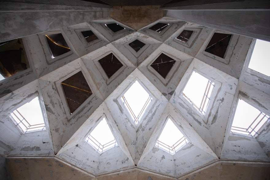 Looking up towards the intricate geometry of the roof structure.