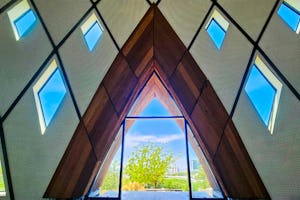 Local craftsmen in PNG have hand carved 432 timber panels that now frame the nine doors of the rising House of Worship.