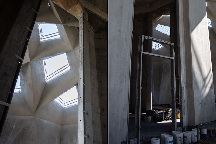 Left: The metal framing that will receive the stained glass is fastened to the columns of the central edifice. Right: The frame that will eventually receive wooden doors opening into the edifice.
