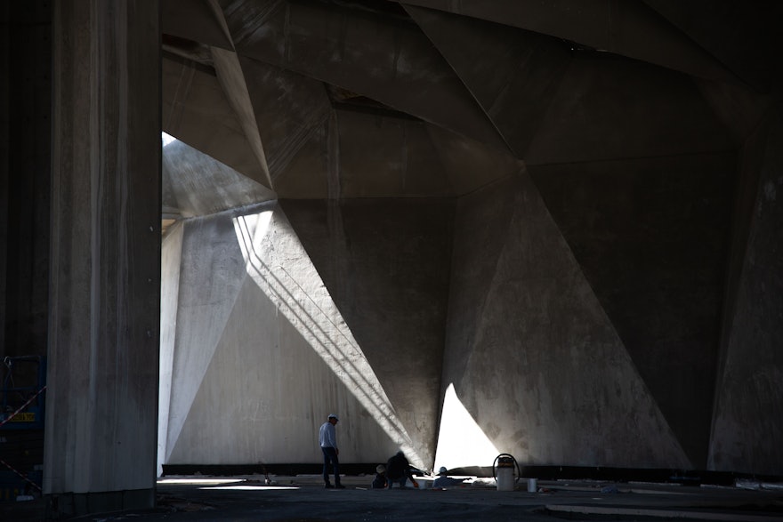 Light streams through one of the open skylights on to the western folding walls of the central plaza.