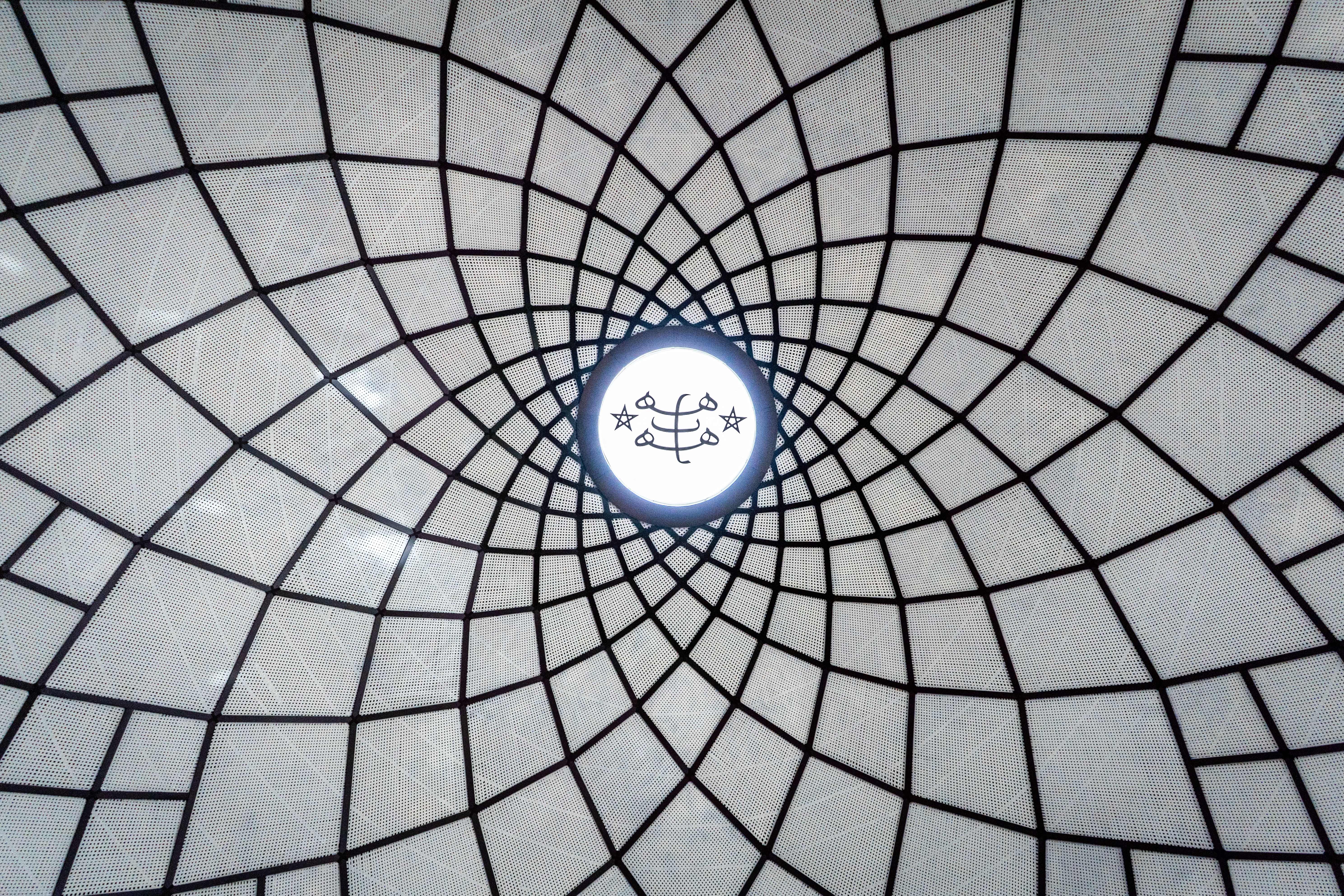 The sacred Bahá’í symbol known as the Greatest Name has been placed at the apex of the dome of the temple. The Greatest Name is a calligraphic representation of the invocation “O Glory of the All-Glorious.”