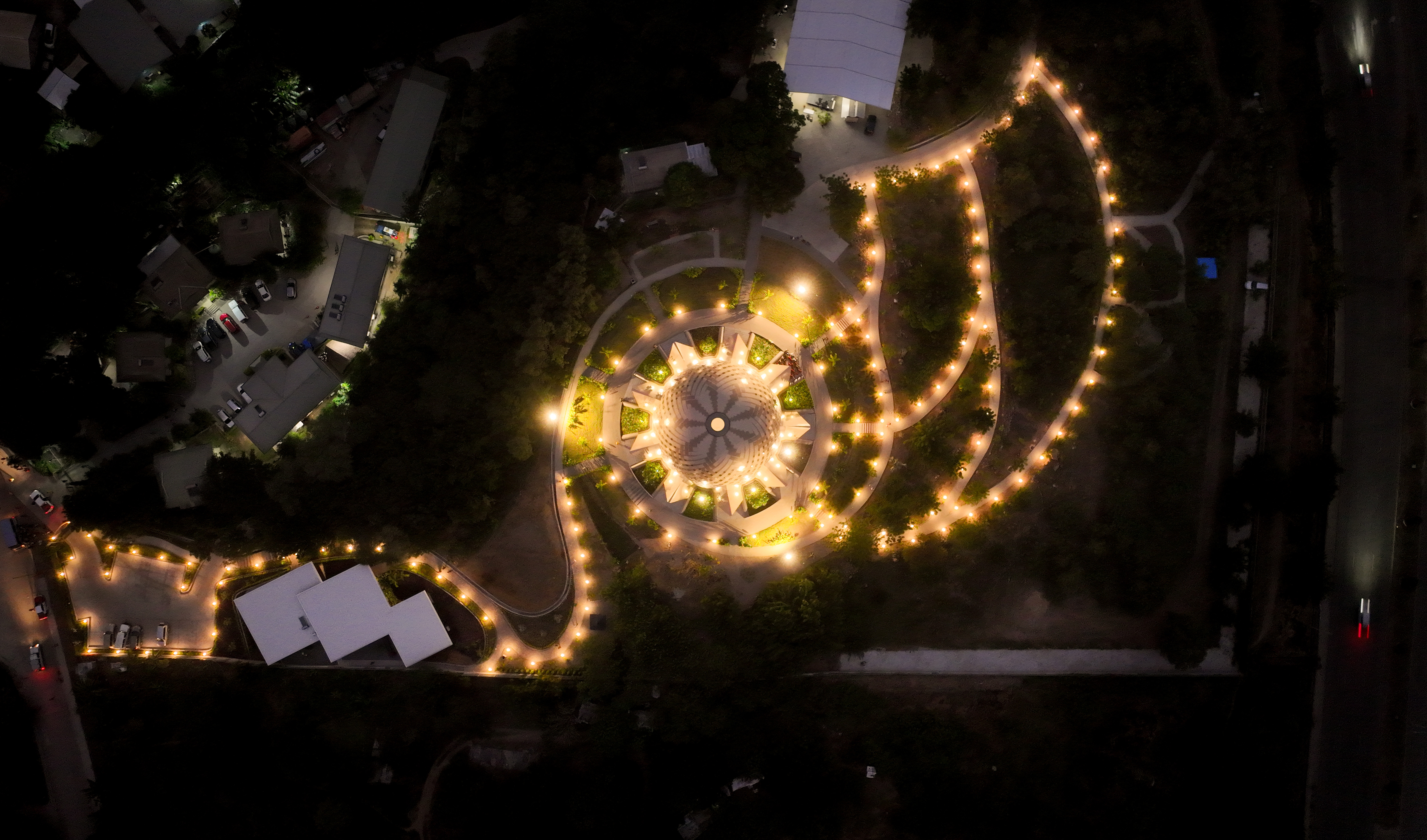 The House of Worship illumined at night.