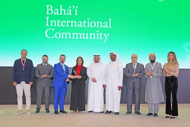 The conference presented trophies to sponsors and partners in recognition of their valuable contributions. Pictured here, Roeia Thabet accepts the trophy given to the Office of Public Affairs representing the Bahá'í community in the United Arab Emirates.