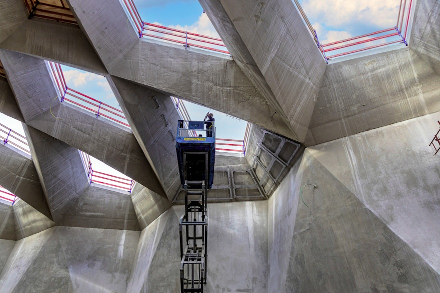 Each metal frame is curvilinear, accommodating the shape of the specific marble piece it will house. This intricate installation system was designed by Margraf, the Italian company that cut and shaped the marble for the project.