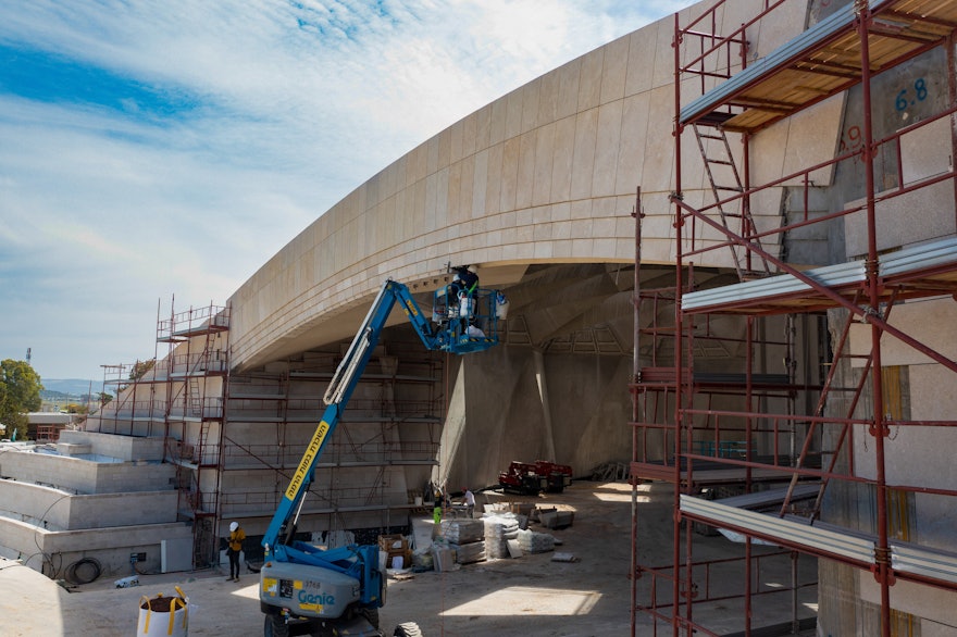 Laying of local stones on the portal wall of the north plaza is close to completion.