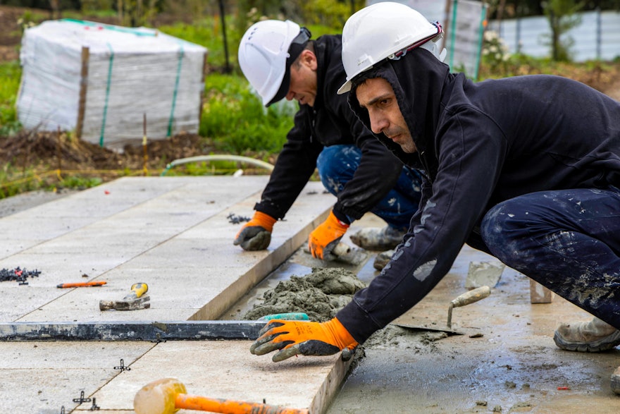 Local stones being placed for the entry path.