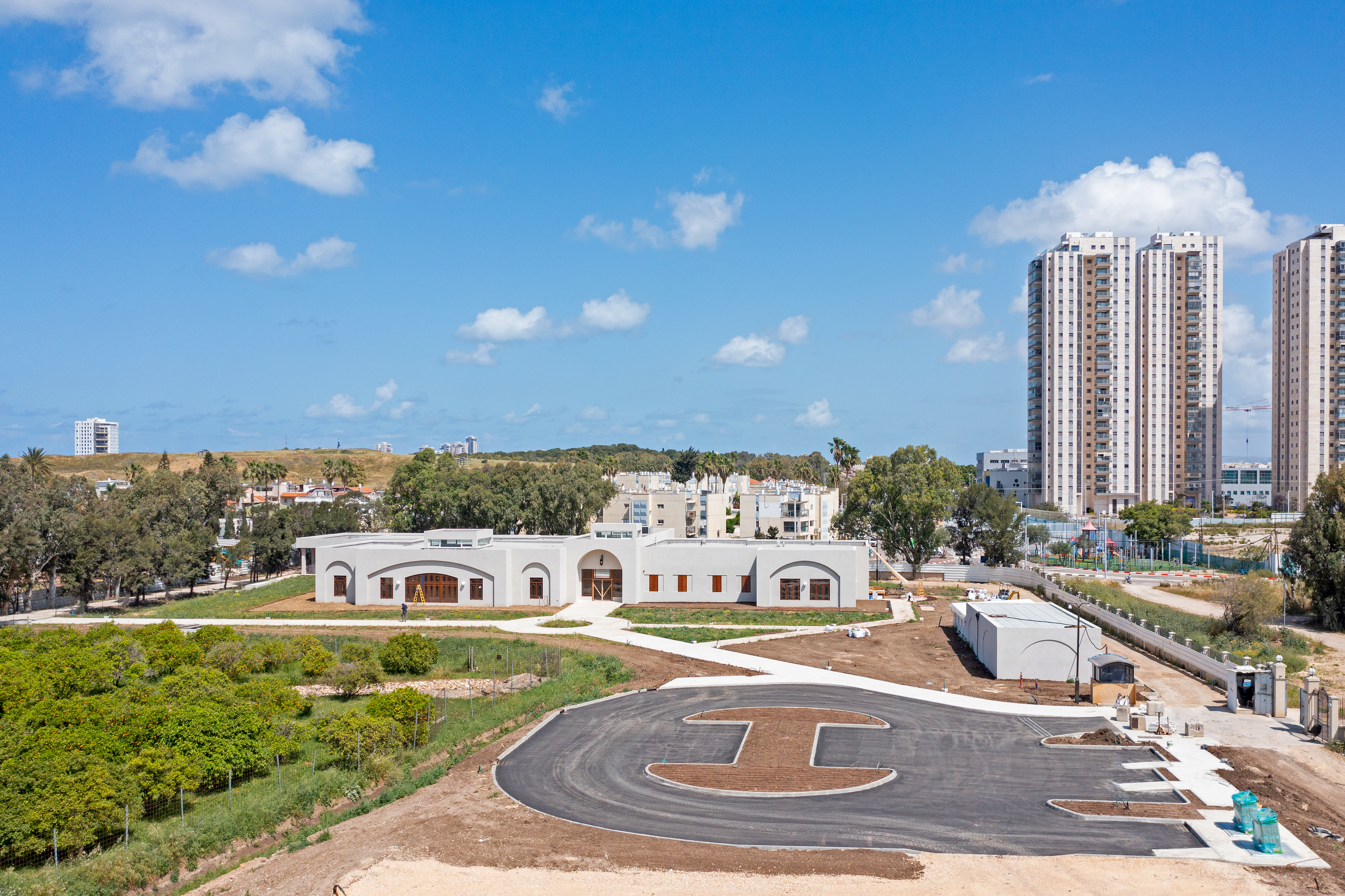 View of the ‘Akká Visitors’ Centre nearing completion, with work progressing on the surrounding parking area and pathways leading to and from the building.