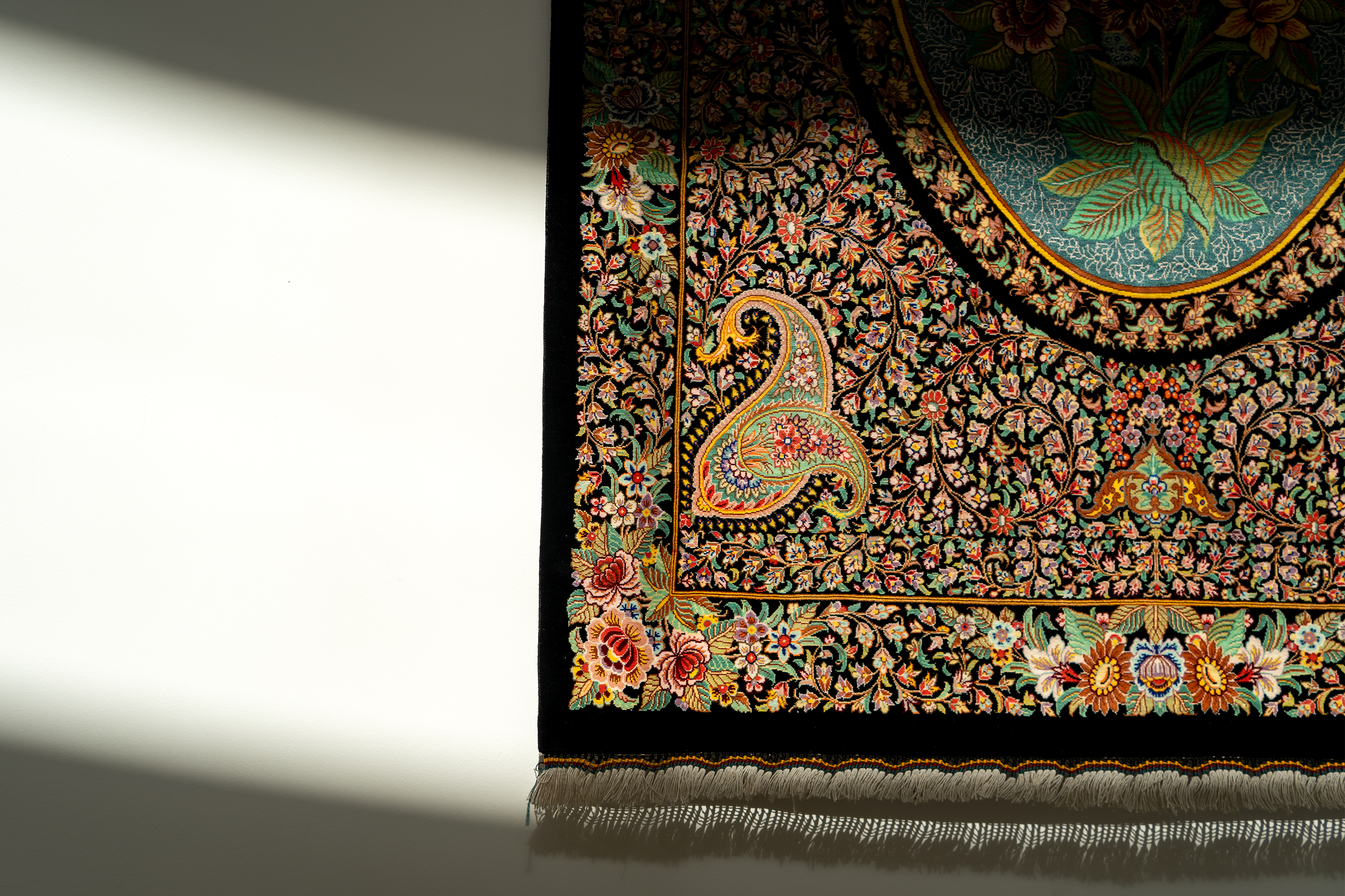 A rug adorns a wall of the foyer.