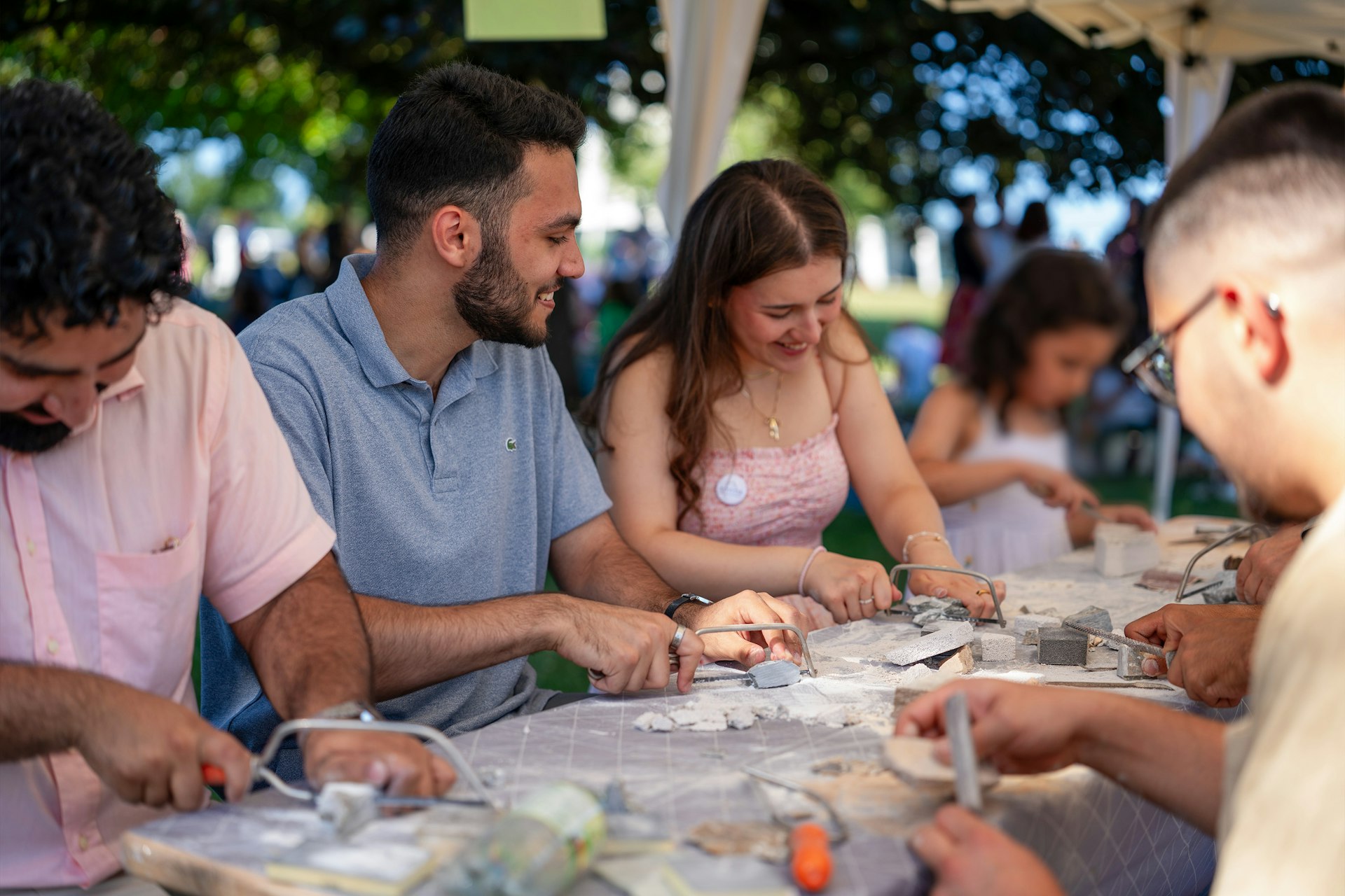 Outdoor tents invited hands-on participation in crafts and artistic activities.