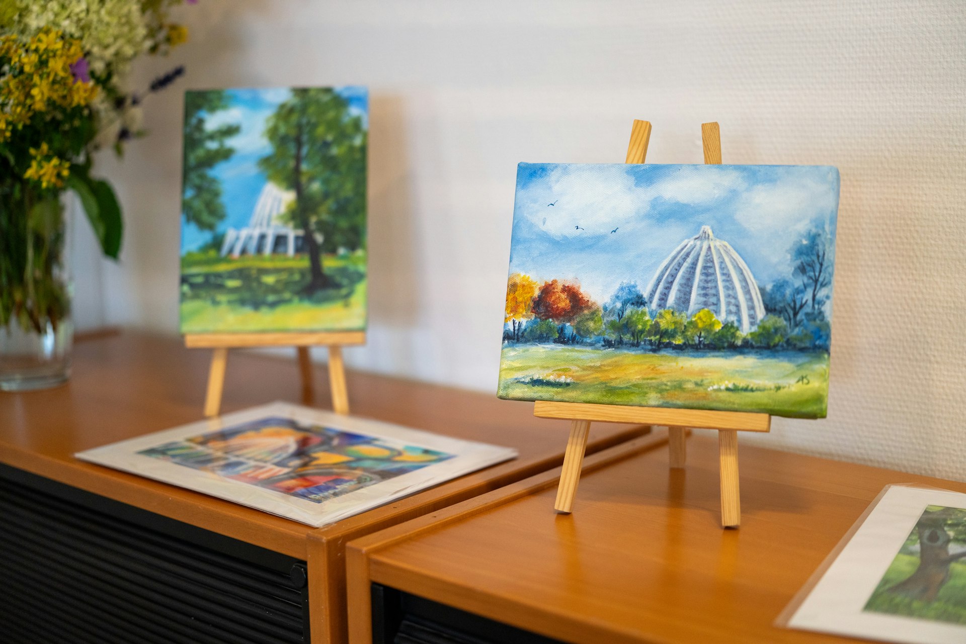 Paintings of the Bahá’í House of Worship in Langenhain, Germany, on display in the visitor center.