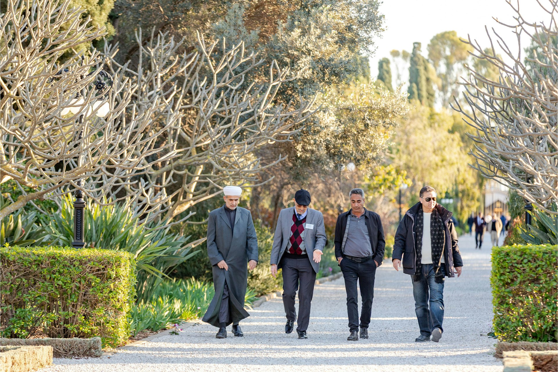A view of participants walking through the surrounding gardens of the Shrine of Bahá’u’lláh.
