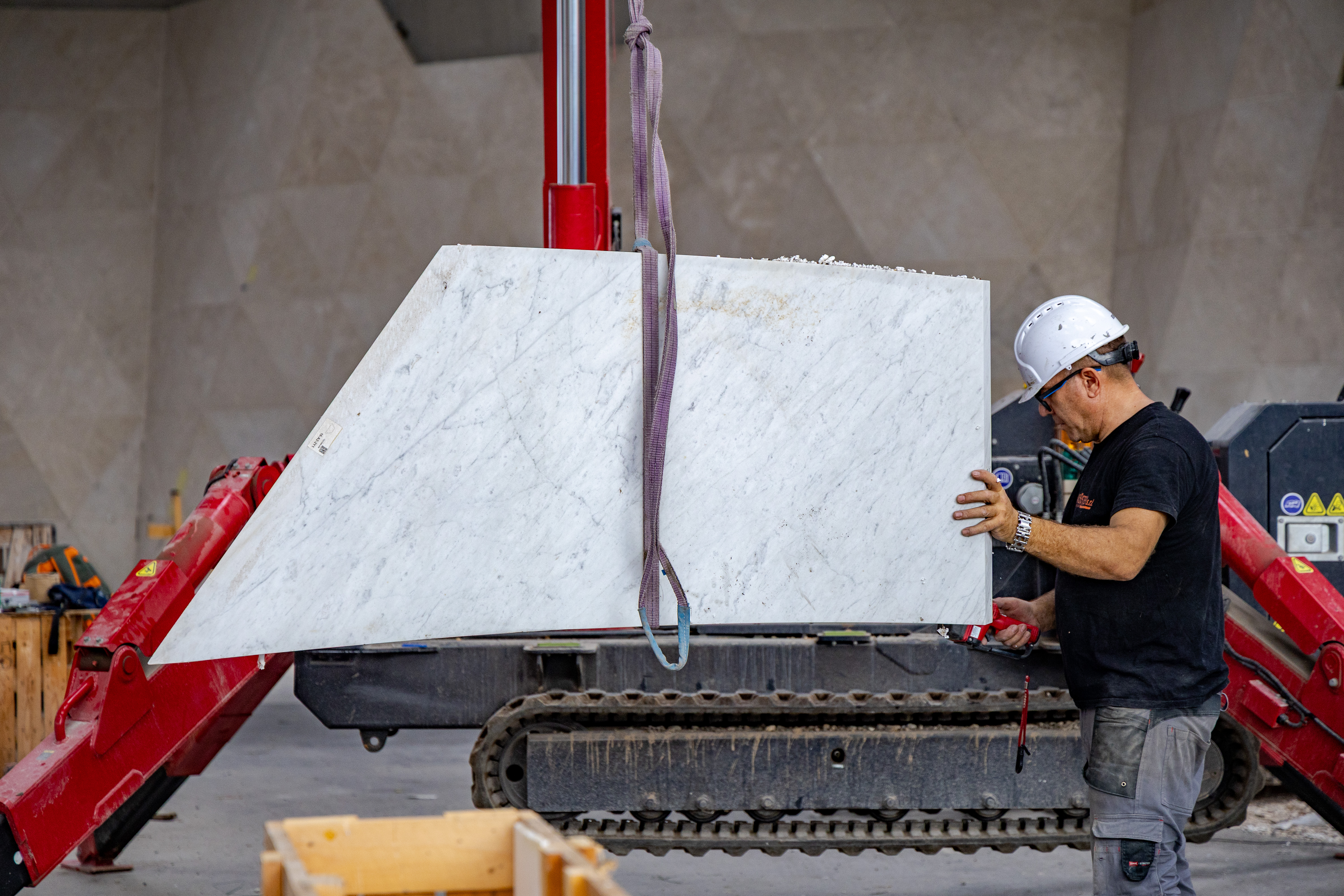 The marble is carefully lifted from the crates using a spider lift to assemble the marble at the skylight opening.
