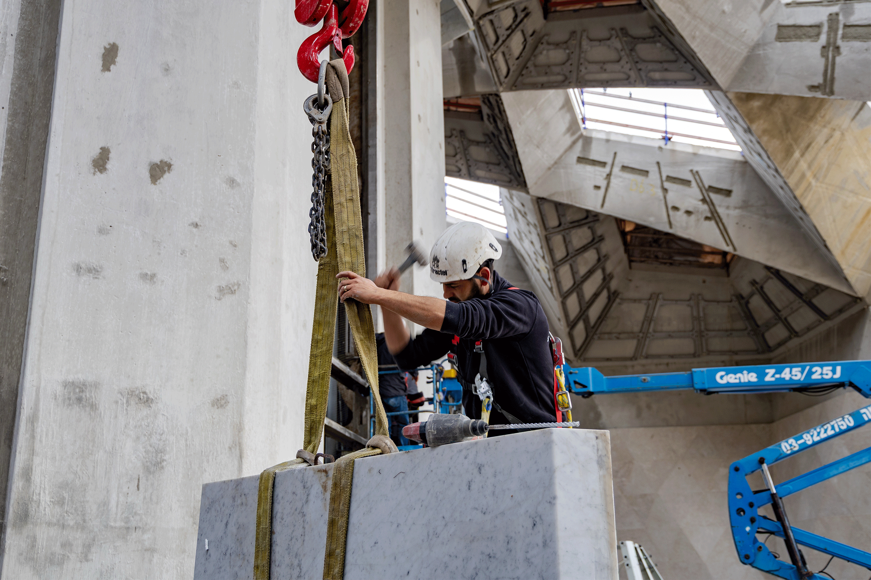 The marble is carefully lifted from the crates using a spider lift to assemble the marble at the skylight opening.