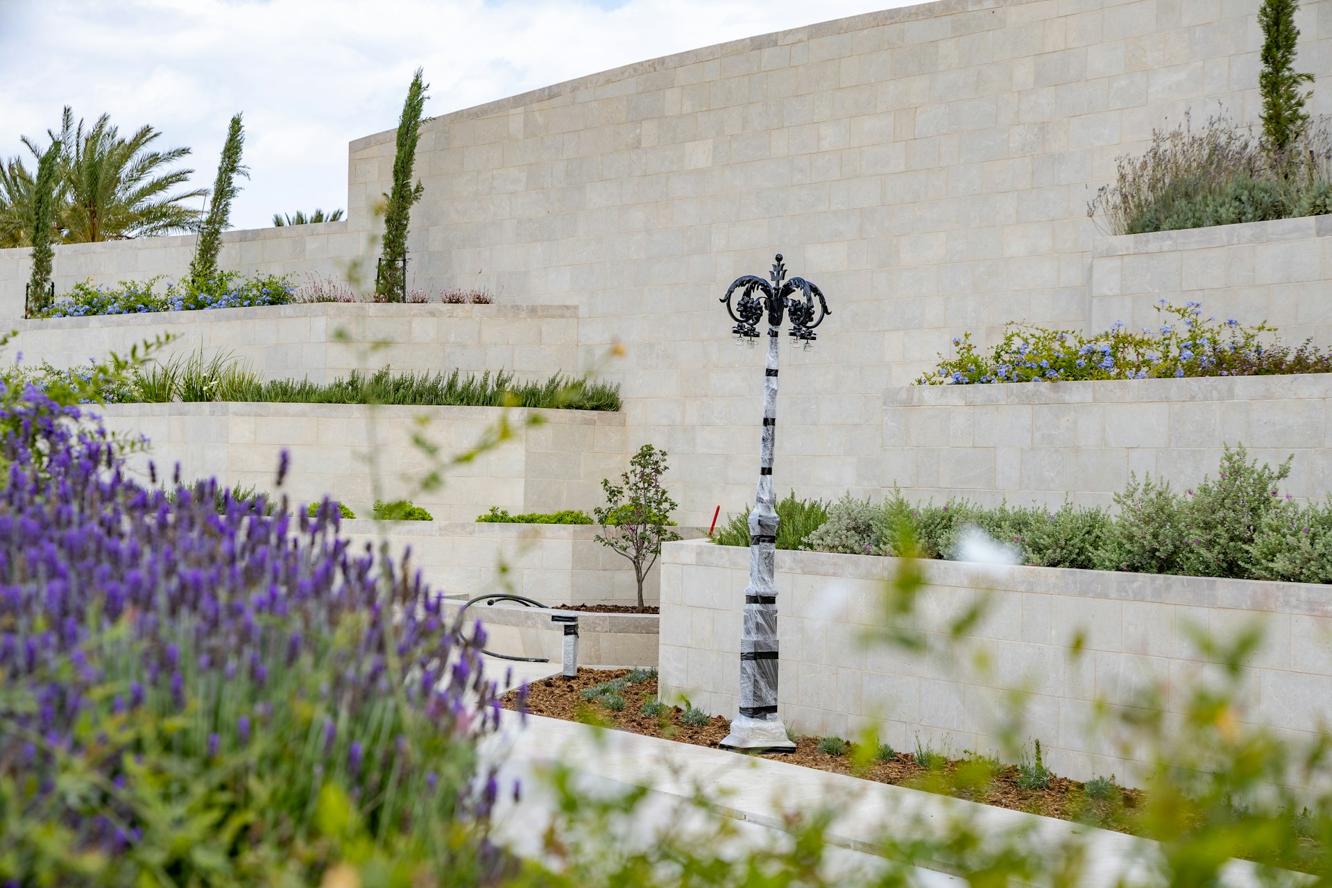 Lighting installation work is advancing across the site.