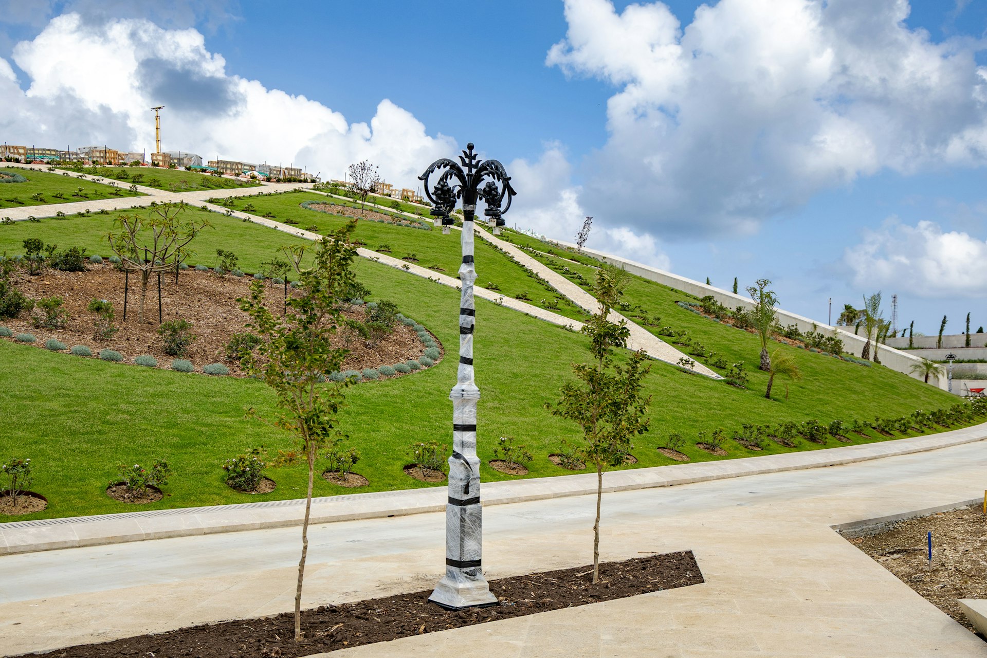 Lighting installation work is advancing across the site.