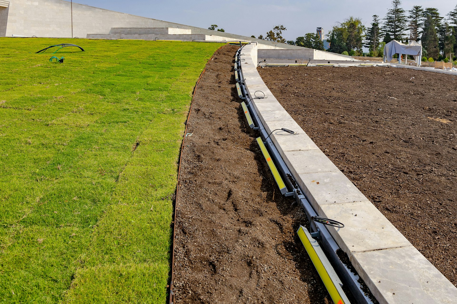 Lighting installation work is advancing across the site.