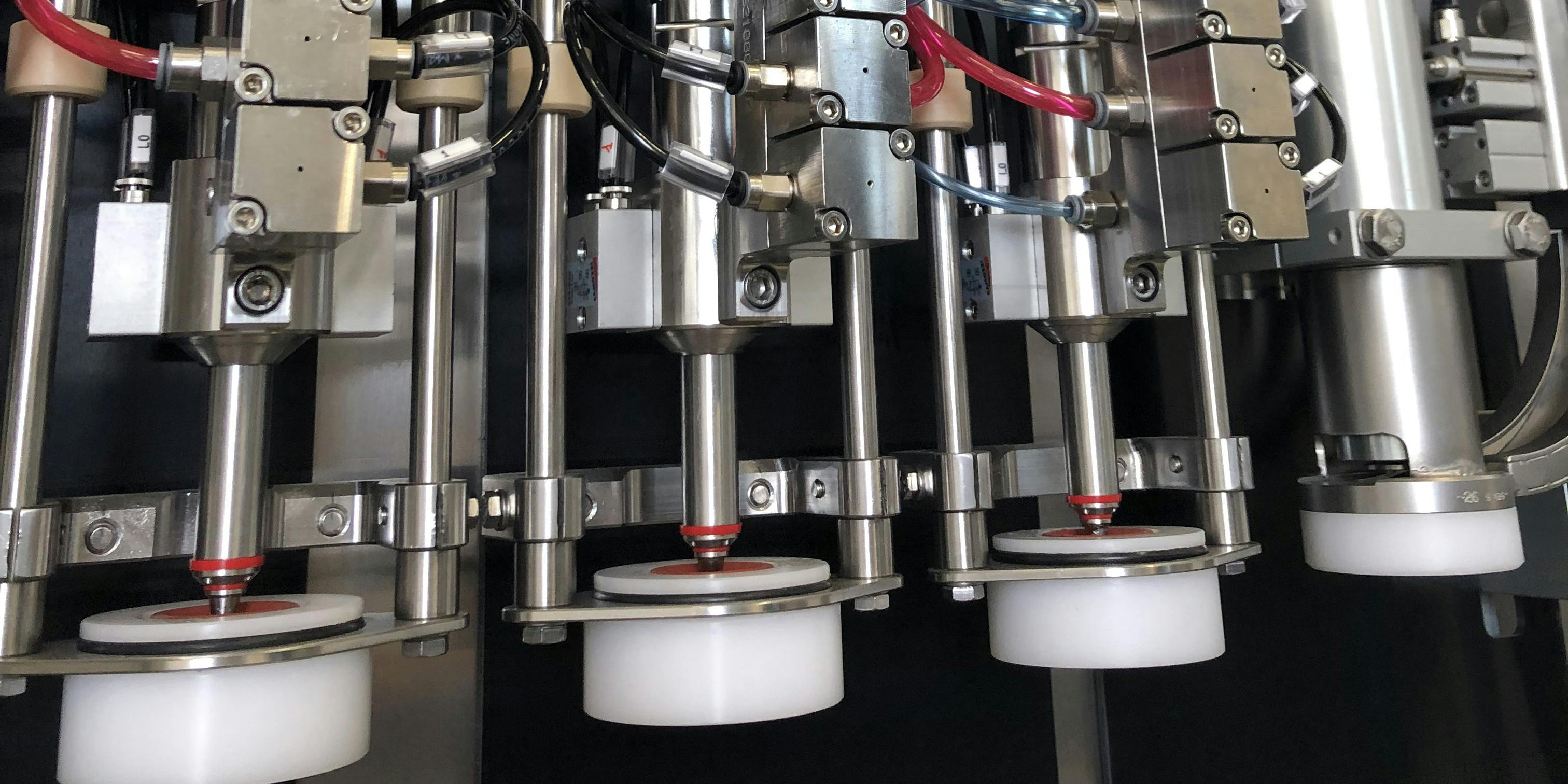 This photo showing tree RIDC (double closing isobaric nozzle) nozzles in the foreground, suitable for filling beer and wine