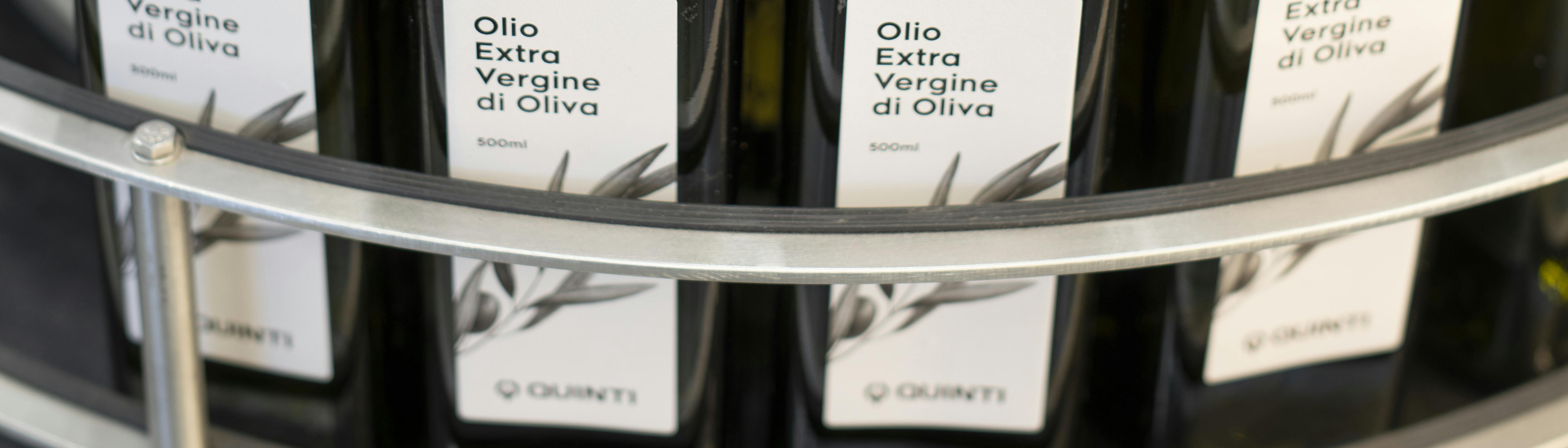 A table suitable for the accumulation of bottles, in this case there are bottles of oil with black caps and personalized Quinti label