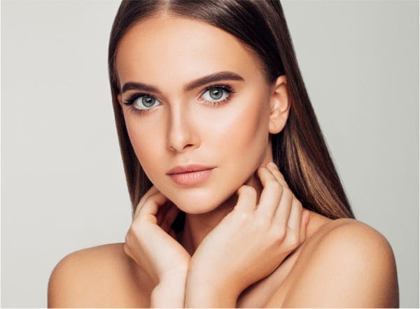 Beautiful woman with her hands up near her neck