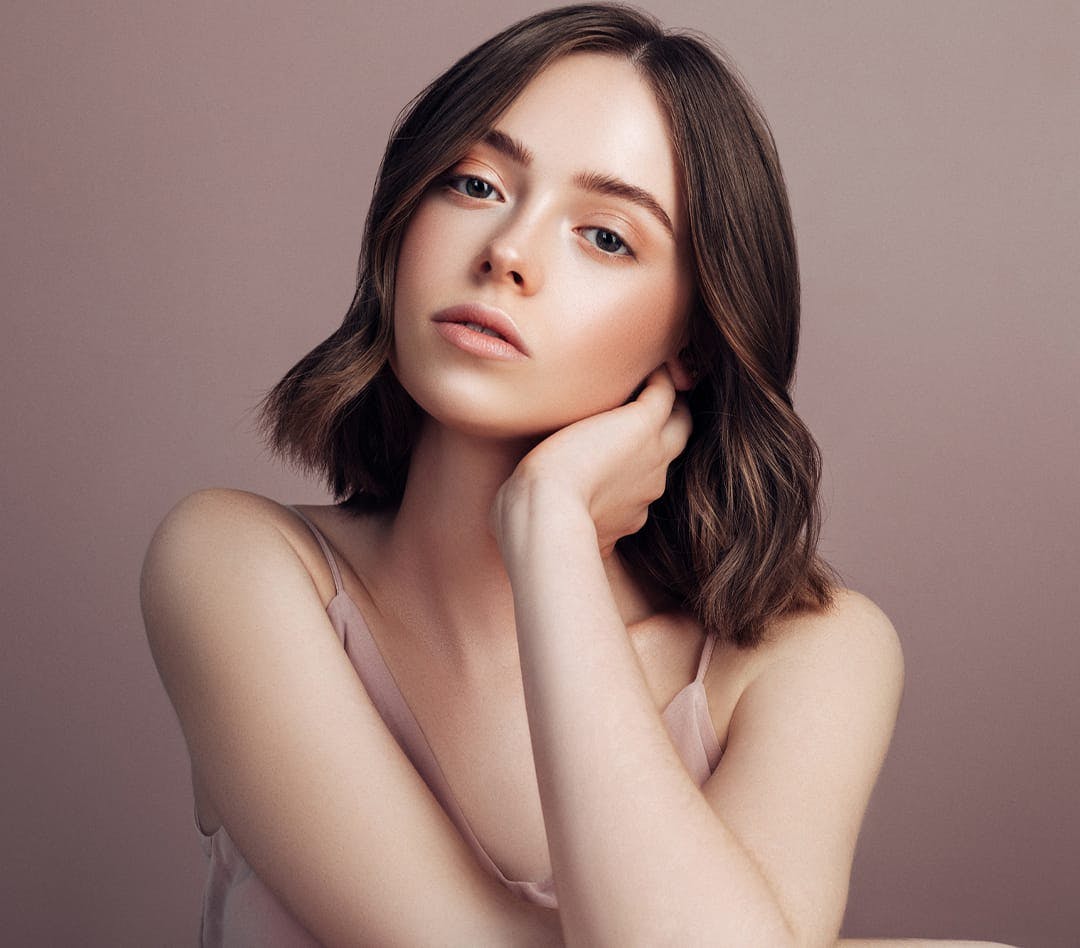 Woman with short brown hair and clear skin