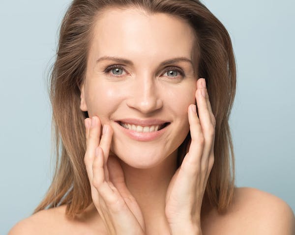 Beautiful woman smiling touching her cheeks